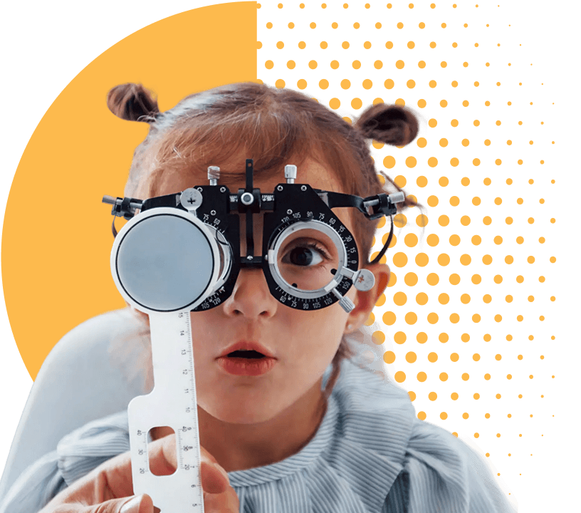 A young girl wearing a trial lens frame during an eye examination