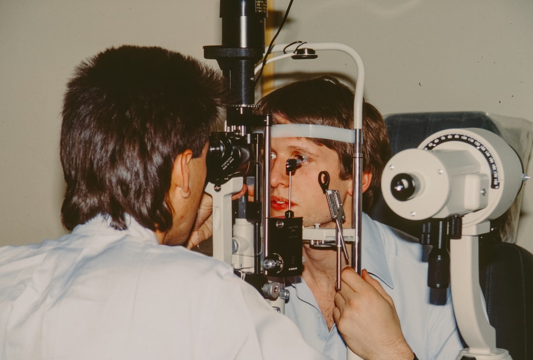 An optometrist examining a child&rsquo;s eyes during a routine appointment